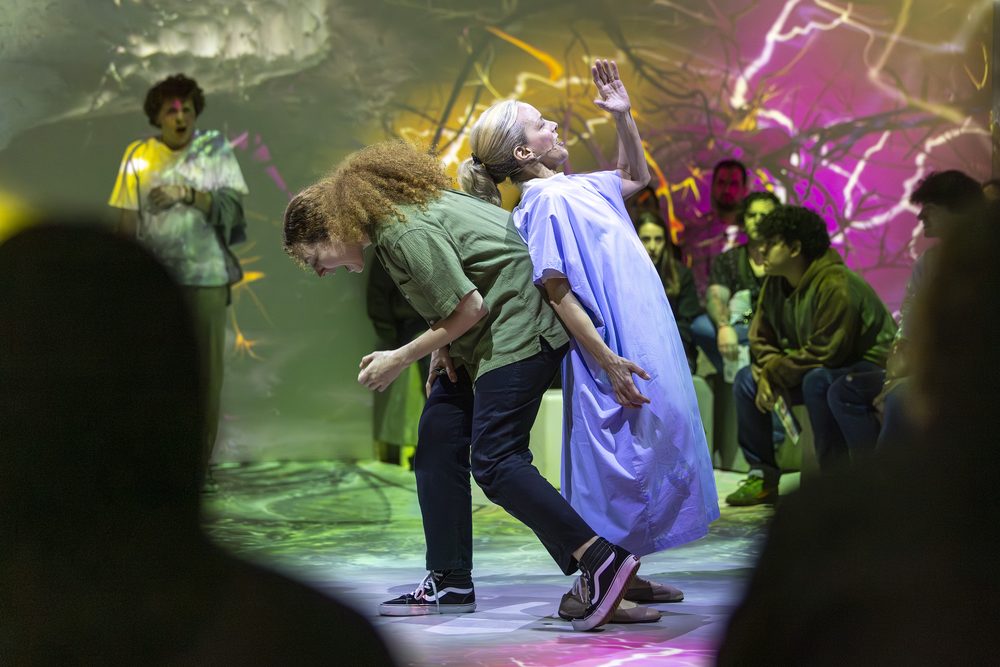 Next to Normal (Immersive), directed by Simon Pittman — two performers back to back amid the surrounding audience. Photo by Chaskielberg.